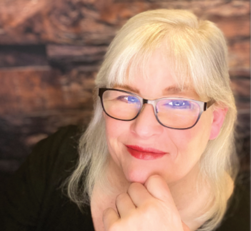 Suzie Donahue smiles looking at the camera