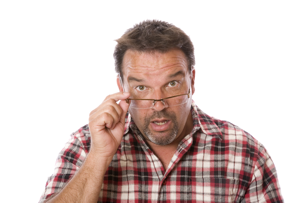 a guy in his forties looking over his eyeglasses